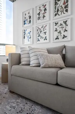 a couch in a living room with paintings on the wall at Free Parking Downtown Condo with Resort Amenities in Miami