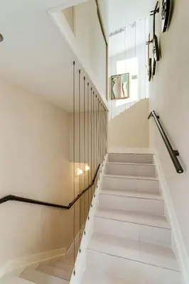 a staircase in a house with glass railing at Casa Anton- Artist Home Pool & Rooftop Hot Tub in Miami