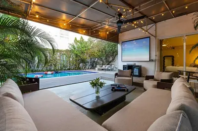 a living room with a pool and a tv at Casa Anton- Artist Home Pool & Rooftop Hot Tub in Miami