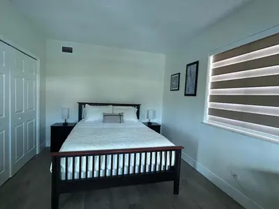 a bedroom with a bed and a window at Spring Village by the Canal Loft in Miami