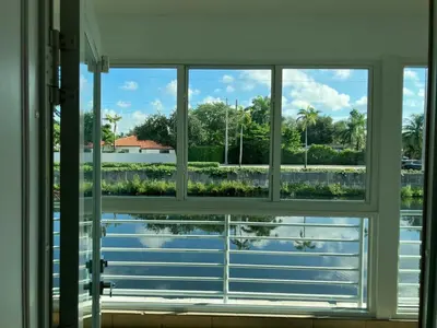 an open window with a view of a body of water at Spring Village by the Canal Loft in Miami