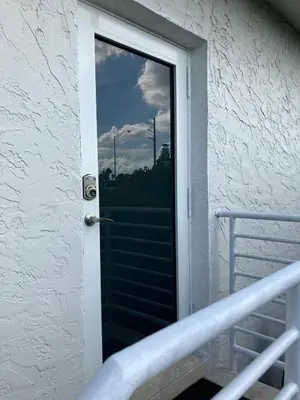 a door to a balcony with a view at Spring Village by the Canal Loft in Miami