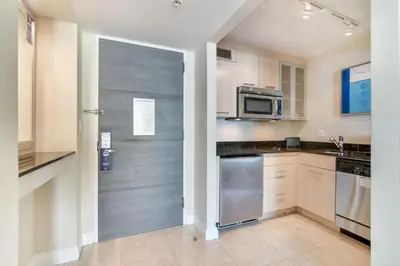a kitchen with stainless steel appliances and a sliding door at Intracoastal Oasis in Fort Lauderdale
