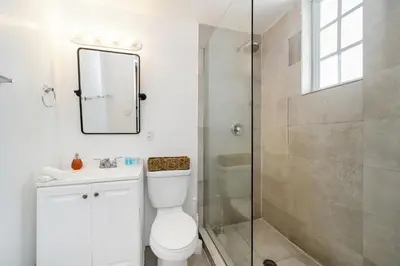 a bathroom with a shower and a toilet and a sink at Drexel Apts By At Mine Hospitality in Miami Beach