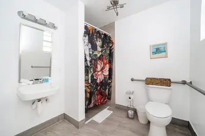 a bathroom with a toilet and a sink at Drexel Apts By At Mine Hospitality in Miami Beach