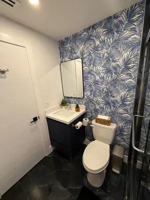 a bathroom with a toilet and a sink and a mirror at 76 Tropical Retreat in Miami in Miami