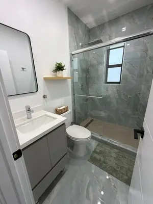 a bathroom with a shower and a toilet and a sink at 78 Tropical soak in Miami
