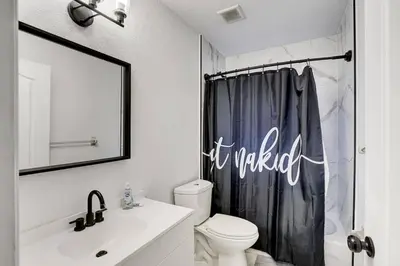 a bathroom with a toilet and a shower curtain at 397 A - Beautiful Home in Miami in Miami