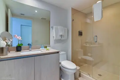 a bathroom with a toilet and a sink and a shower at Prime Oceanfront 3BR Mansion in the Sky in Hollywood