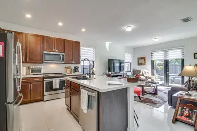 a kitchen with stainless steel appliances and wooden cabinets at Easy Park and University Access! Family Miami Escape in Miami
