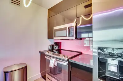 a kitchen with a stove and a microwave at Luxe Miami Vice Condo! Bay Views and Pool Access in Miami