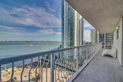 a balcony with a view of the beach and buildings at Luxe Miami Vice Condo! Bay Views and Pool Access in Miami