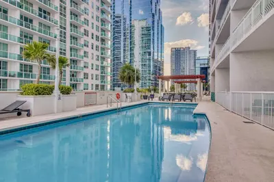 a swimming pool in a city with tall buildings at Luxe Miami Vice Condo! Bay Views and Pool Access in Miami