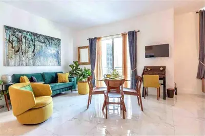 a living room with a couch and a table and chairs at Downtown Apartment with free parking near Brickell in Miami