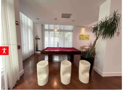 a room with a ping pong table and two stools at Downtown Apartment with free parking near Brickell in Miami