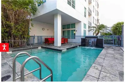 a swimming pool in front of a building at Downtown Apartment with free parking near Brickell in Miami