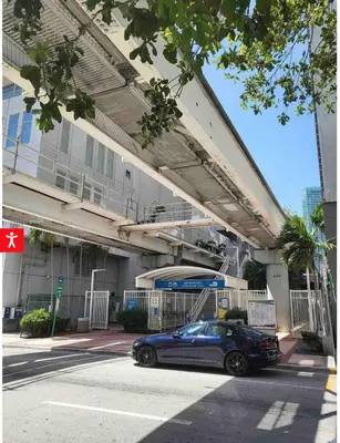 a blue car parked in front of a building at Downtown Apartment with free parking near Brickell in Miami