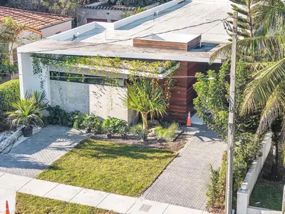 a house with a garden in front of it at Luxury Pool Home - Downtown Brickell in Miami