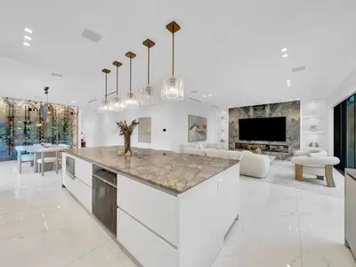 a kitchen with a large island in a living room at Luxury Pool Home - Downtown Brickell in Miami