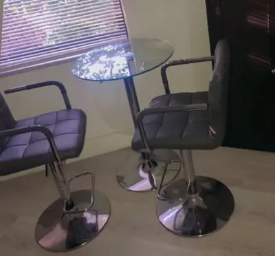 two chairs and a glass table and a table and chairs at Spacious and affordable! in Hollywood