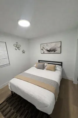 a bedroom with a large white bed with two pillows at Fort Lauderdale Airport Pacifica Lake Bleu in Dania Beach