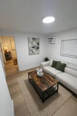 a living room with a couch and a coffee table at Fort Lauderdale Airport Pacifica Lake Bleu in Dania Beach