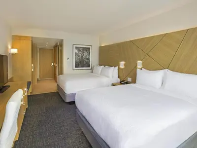 a hotel room with two beds and a television at Novotel Miami Brickell in Miami