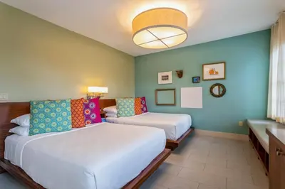 a hotel room with two beds and a window at Kasa El Paseo Miami Beach in Miami Beach