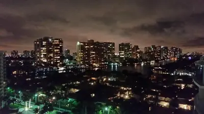 a city skyline at night with a river and buildings at Penthouse Ocean Reserve in Miami Beach