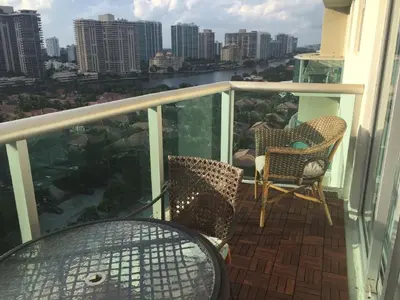 a balcony with two chairs and a view of a city at Penthouse Ocean Reserve in Miami Beach
