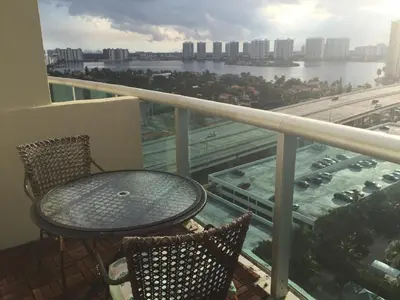 a table and chairs on a balcony with a view of a river at Penthouse Ocean Reserve in Miami Beach