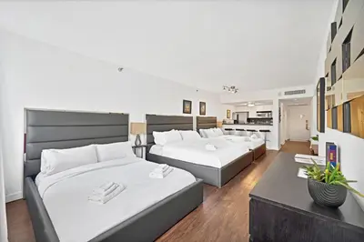 a bedroom with two beds and a living room at Casa Grande Suites on Ocean Drive in Miami Beach
