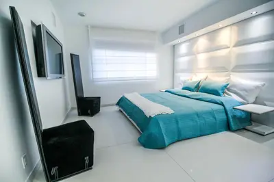 a bedroom with a bed and a television in it at Casa Grande Suites on Ocean Drive in Miami Beach