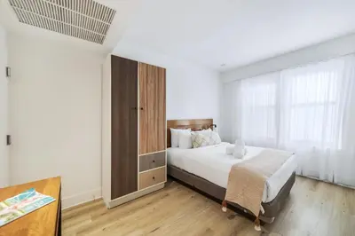 a bedroom with a bed and a large window at The Meridian Hotel by At Mine Hospitality in Miami Beach