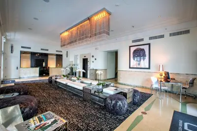 a large living room with a couch and a table at Dream South Beach, by Hyatt in Miami Beach