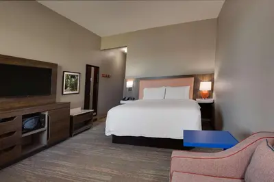 a hotel room with a bed and a flat screen tv at Hampton Inn & Suites Fort Lauderdale - Miramar in Miramar