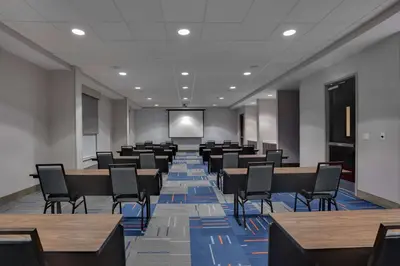 a conference room with tables and chairs and a screen at Hampton Inn & Suites Fort Lauderdale - Miramar in Miramar