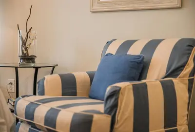 a living room with a chair and a blue pillow at Cadet Hotel in Miami Beach