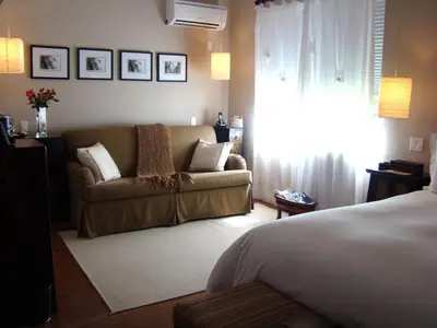 a living room with a couch and a bed at Cadet Hotel in Miami Beach