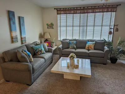 a living room with two couches and a coffee table at PlayaBlanco Suites in Fort Lauderdale