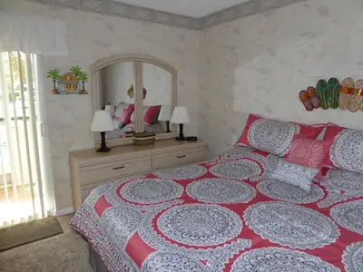 a bedroom with a red and white bed and a mirror at PlayaBlanco Suites in Fort Lauderdale