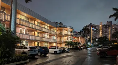 a parking lot in front of a large building at PlayaBlanco Suites in Fort Lauderdale
