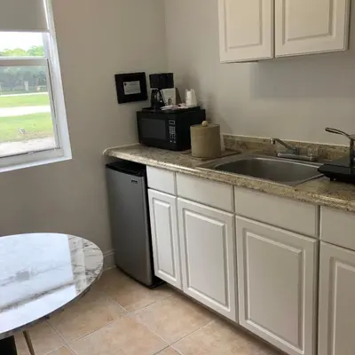 a kitchen with a sink and a microwave at Beach Place Hotel in Miami Beach