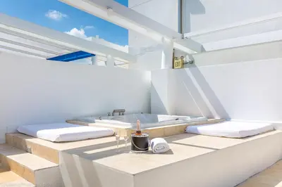 a white bathroom with a sink and two beds at SBV Luxury Ocean Hotel Suites in Miami Beach