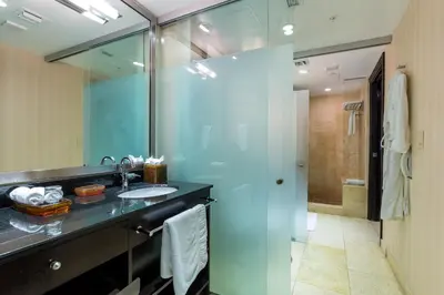 a bathroom with a sink and a glass shower at SBV Luxury Ocean Hotel Suites in Miami Beach