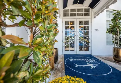 a welcome mat in front of a door with an oceanquist show sign at Oceanside Hotel and Suites in Miami Beach