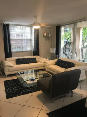 a living room with couches and a glass table at The Nautical! Amazing 3Bed 2Bath Apartment at Aventura Yacht Club in Aventura