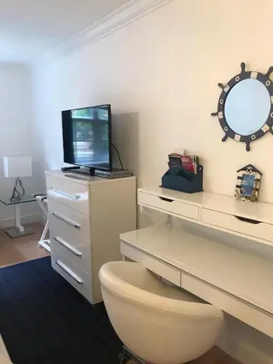 a bathroom with a desk with a toilet and a mirror at The Nautical! Amazing 3Bed 2Bath Apartment at Aventura Yacht Club in Aventura