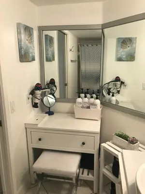 a bathroom with a dressing table and a mirror at The Nautical! Amazing 3Bed 2Bath Apartment at Aventura Yacht Club in Aventura