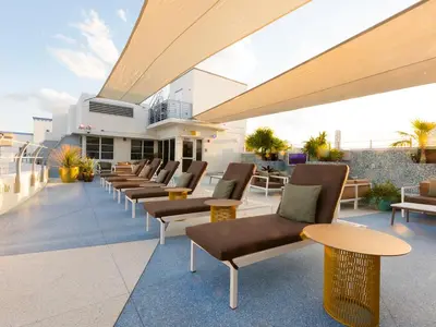a row of chairs and tables on a rooftop patio at Clevelander Hotel in Miami Beach